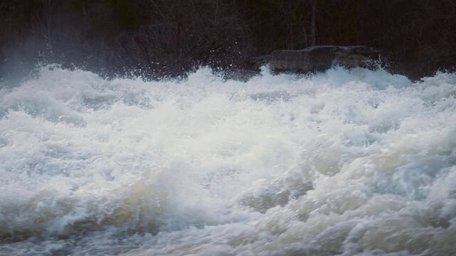 Spring currents crash over the limestone shelf at Sauble Falls, Ontario. The high frame rate highlights details of white foam, splashing waves, and mist rising from the rapids.
