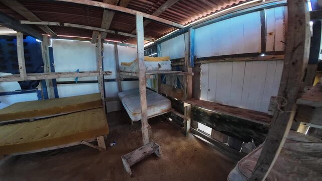 360-degree turn inside an austere, makeshift cabin for fishermen in Los Roques, Venezuela, revealing worn bunk beds and sand floor.