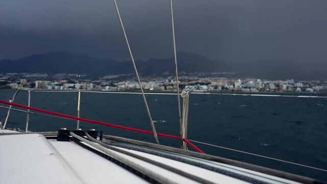 serene bridge static view over harbor with boats and mountains in overhead perspective, metallic structure, water surface, boat hulls, travel and tourism, landscape photography.
