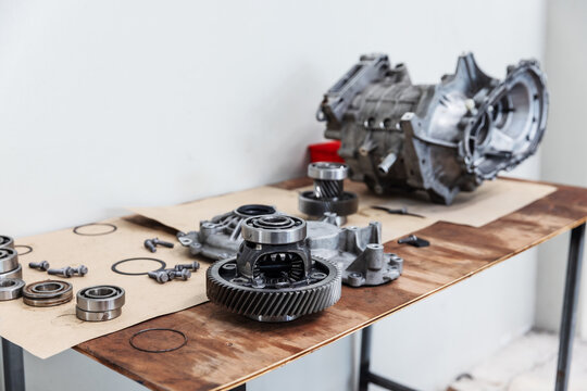 Disassembled electric vehicle drive unit components arranged on a workshop bench during inspection and overhaul.