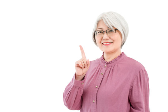 A smiling senior woman with gray or silver hair (recommended, pointing, guided, introduced)