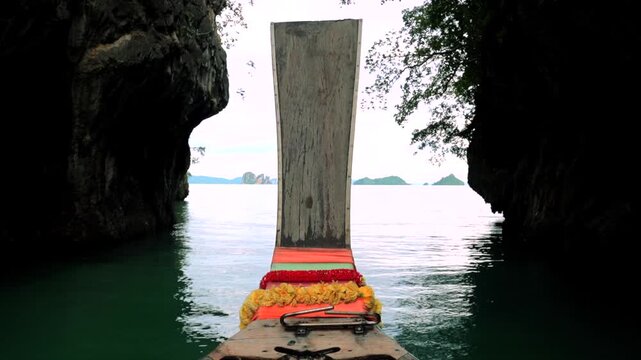 serene traditional boat floating on lagoon with karst formations first-person perspective from wooden boat adventure in nature blue and green water clean background.