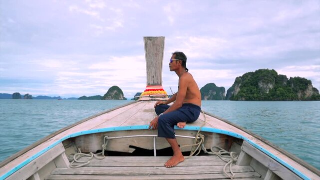 man sitting on a wooden boat, looking forward at rocky islands in the ocean, relaxed and contemplative side view, travel adventure nature scene, blue and gray tones, clean background.