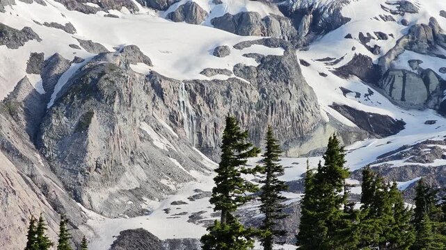 Snowy mountain peak with waterfall and evergreen trees in Washington