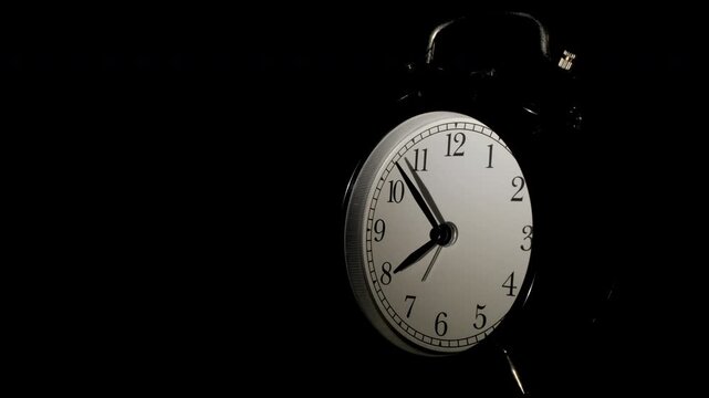 Tme lapse video of a clock time passing over a day to night on black background.
