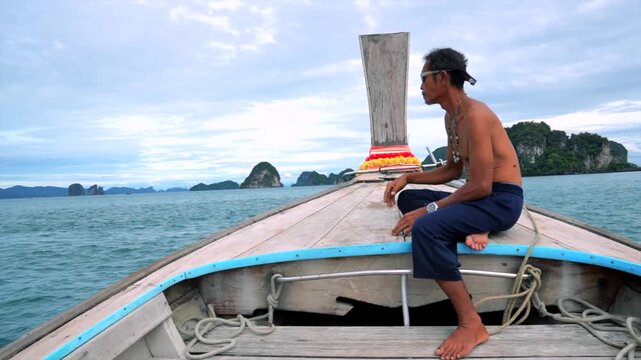 Man sitting on a boat relaxing and gesturing with hands, in ocean with rocky islands in the background, with boat, water, rocky islands, with wooden boat, rope texture.