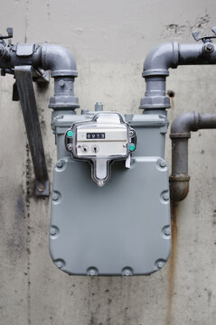 Natural gas meter outside. Outdoor meter measuring and displaying usage number in cubic feet. For residential multi-dwelling building or home. Vancouver, BC, Canada. Selective focus.