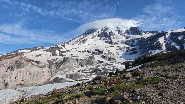 Panoramic view of snow-covered Mount Rainier peak with lenticular cloud