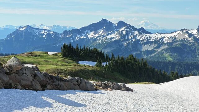 Panoramic view of snow-covered mountains and evergreen forest in Washington