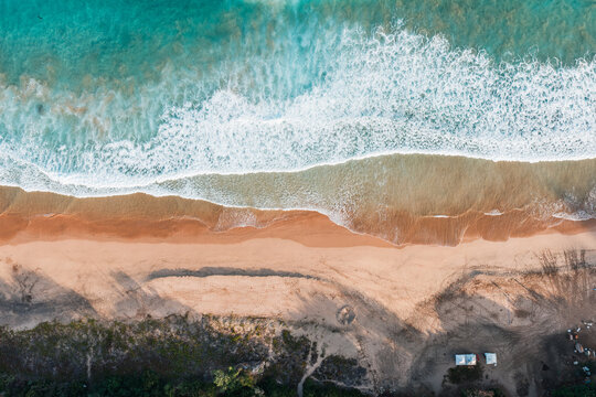 Aerial top view of waves and sand patterns on the beach, Fernando de Noronha, Pernambuco, Brazil