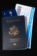 US passport with boarding pass and credit card. Travel documents for airport check in and international flight concept. American passport visa and border control theme. Boarding pass and payment card. © Svitlana