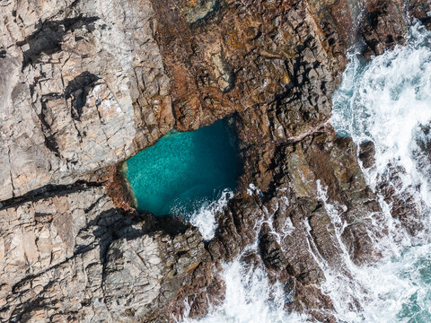 Aerial top view of a natural rock pool with turquoise water, Fernando de Noronha, Pernambuco, Brazil