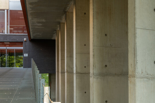 Hasselt, Belgium. Exposed concrete columns supporting contemporary university building on modern campus