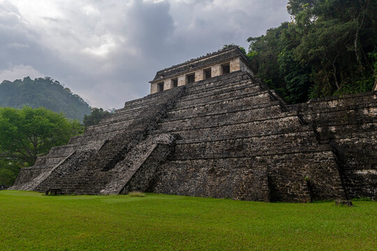 Temple of Inscriptions maya pyramid with dramatic sky, Palenque, Chiapas, Mexico.