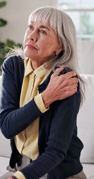 Shoulder pain, stress or senior woman in home with arm injury, muscle tension or arthritis symptom. Retirement, old person or joint sprain on sofa with osteoporosis complication or massage for relief