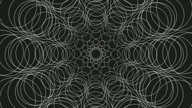Intricate white circular patterns expanding on a dark background