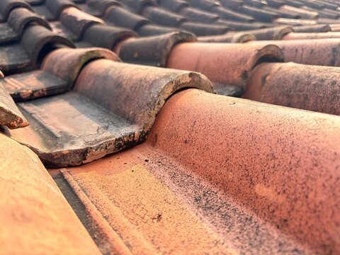 Photo of house roof tiles. House roof. Clay roof tiles.