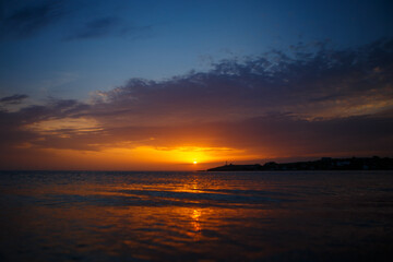Obraz premium Golden Sunset Over the Calm Sea With a Light Path on the Water