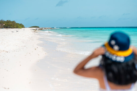 Person walking along Klein Island beach in Cura&ccedil;ao