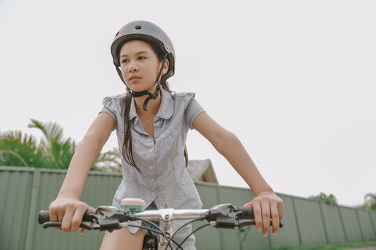 Teen Girl Enjoying a Bike Ride in the Suburbs