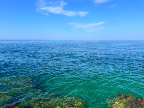 Open sea blue waves and sunny blue sky