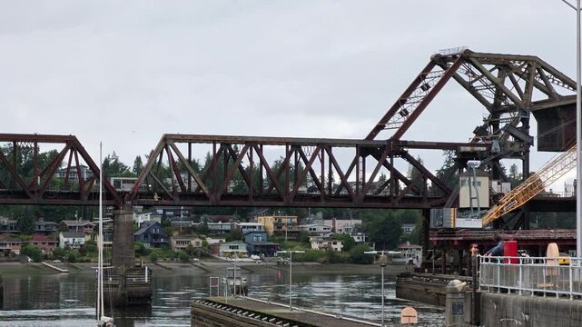 Salmon Bay Bridge drawbridge opening over water with residential houses