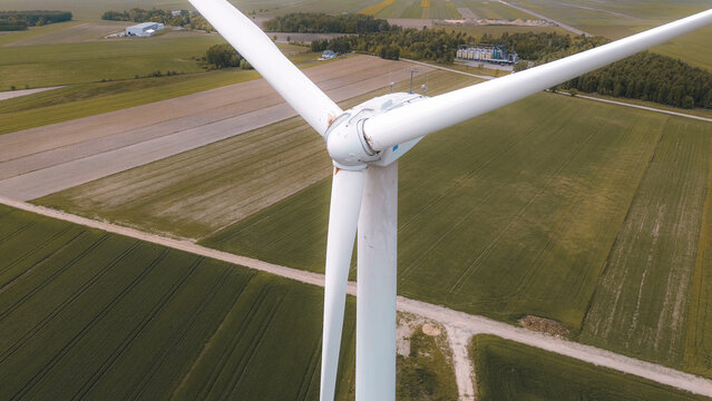 Tall wind turbine against rural landscape