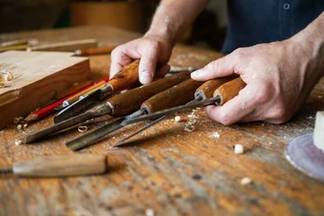 Carpenter hands with handmade wood carving tools set at workbench. Joinery, carpentry, wooden craftsmanship and handwork. © juliasudnitskaya