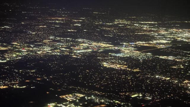 Aerial night view of Oklahoma City lights from airplane window