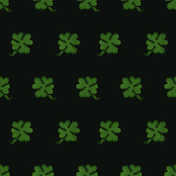 Seamless pattern of green four-leaf clover icons on a black background, designed in a cross-stitch embroidery style. Perfect for St. Patrick's Day themed projects, fabric designs, wrapping paper