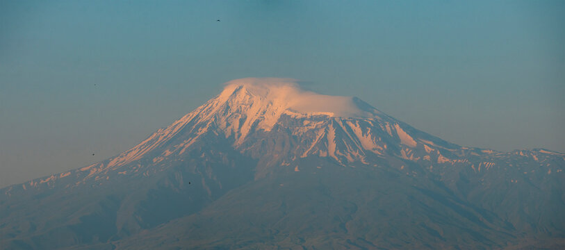 Majestic mount Ararat snow summit at sunset with blue sky copy space