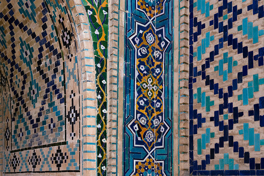Ornate tilework detail of Nadir Divan Begi Madrasah in Bukhara showing intricate geometric and floral mosaic patterns. Ideal for travel publications, cultural heritage projects, design inspiration.