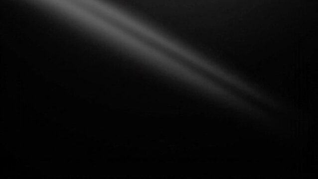 Two parallel beams of light cutting diagonally across a dark, black background, creating a dramatic and mysterious effect with subtle illumination.