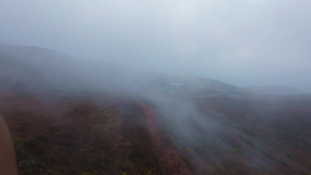 Western Ghats with fog, sky and mud pathway at Baba Budan giri, Chikkamagaluru, Inam Dattathreya Peeta, Nagenahalli, karnataka, india. day time, push in shot, drone shot, 4k.