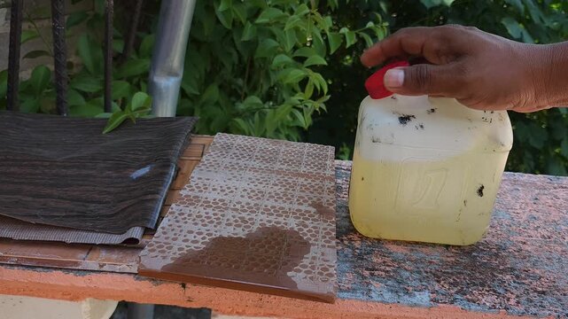 Person closing plastic jug of paint thinner chemical solvent