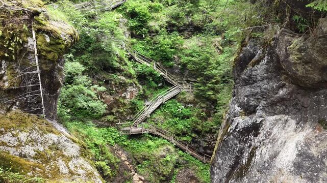 Flattach, Austria - June 12 2026: Raggaschlucht watterfalls and hiking trail. River Ragga. Drone footage. Drone flying over. Aerial footage. Following a bird flying over the river.