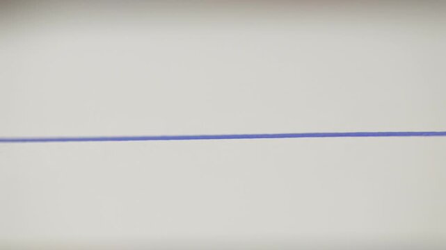 Front close-up of a pencil drawing a precise straight line on white paper. Minimal concept of planning, drafting, design and creative precision.