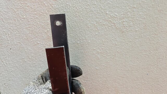 Close up view presenting finished flat bar iron painted matte black