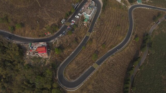 Drone view zigzag road in Mirik, North Bengal, India, at 4,905 feet. Stunning 4K aerial footage showcasing winding mountain roads, lush hills, and scenic Himalayan landscapes near Darjeeling.