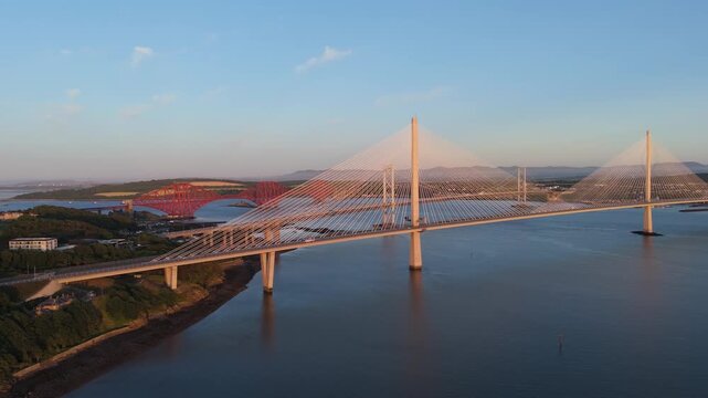 Forth bridges in scotland with traffic during sunset