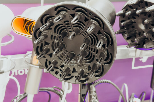 Multiple professional hair dryer diffusers for styling displayed in a store