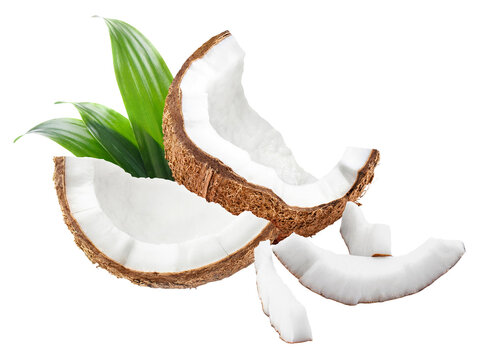 Coconut pieces with green leaves, isolated on transparent cutout background