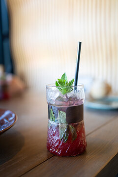 Ice cold homemade lemonade or cocktail with mint, watermelon and fruits on table, refreshing summer drink recipe, detox diet and weight loss concept, menu for restaurant, selective focus.