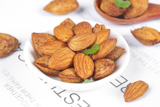 Roasted Almonds in White Bowl - Healthy Natural Snack Food with Mint Garnish