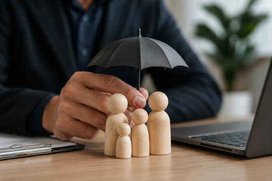 Life insurance concept showing family figures protected under umbrella on policy documents. Represents coverage, beneficiaries, financial security, dependents protection, long-term planning.