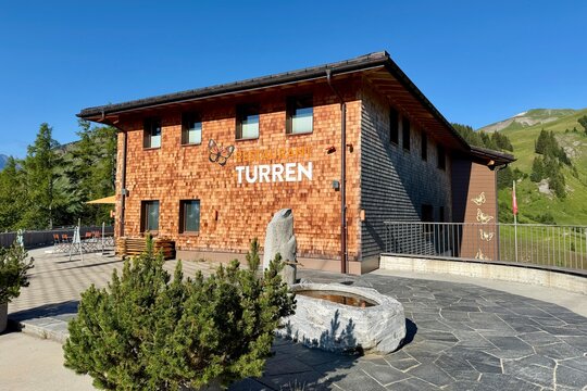 Turren, Switzerland - July 04, 2026: Summer view of the Turren mountain station and panoramic restaurant. Clear blue skies, alpine scenery and popular viewpoint overlooking the surrounding mountains.