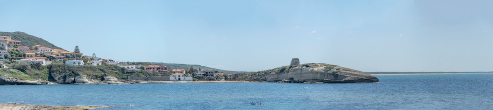 Su Putu tower on rocky cape and village on cove shore, s. Archittu, Oristano, Italy