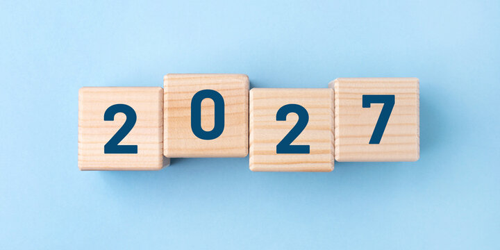 Wooden cubes with numbers of the New Year 2026 on a blue background