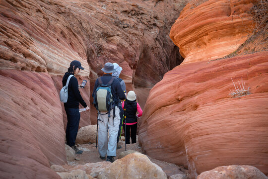 A group of people hiking the narrow slot canyon. Wire Pass trail. Utah. USA.