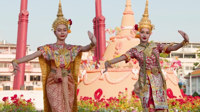 Traditional Thai Dancers Performing in Classical Gold Costumes Outdoors